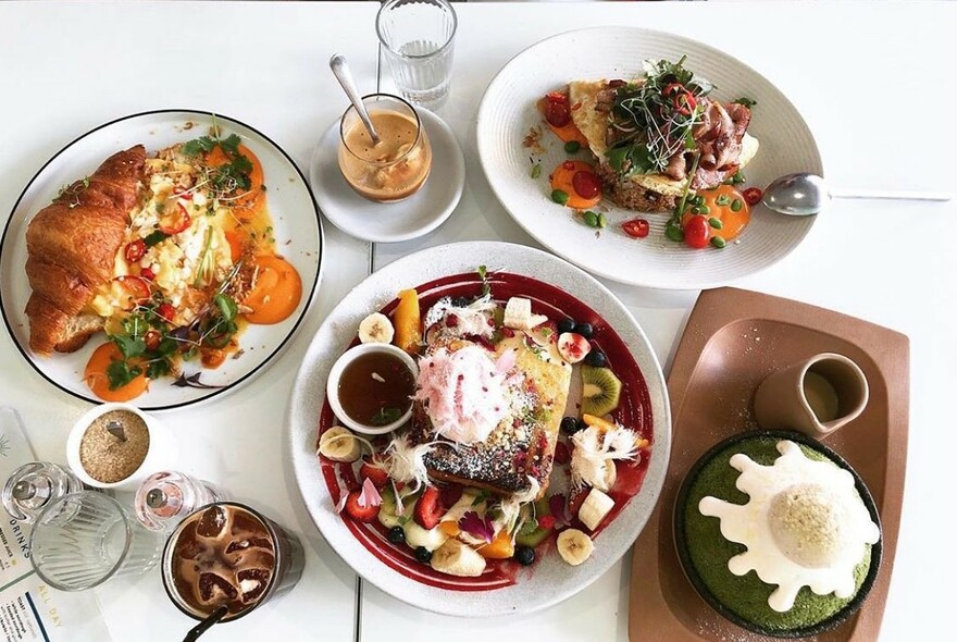 Selection of cafe dishes, including rice pudding and croissants.