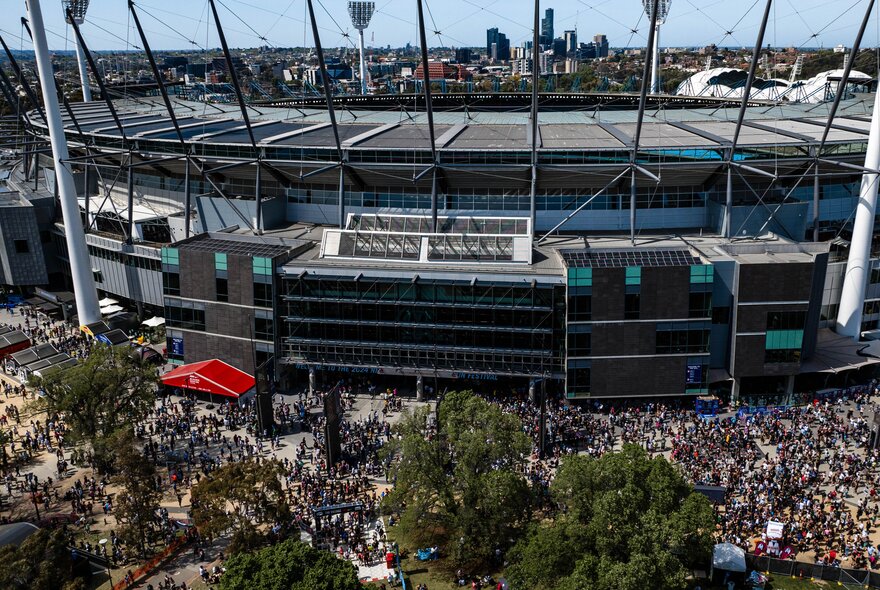 Aerial view of the MCG with large crowds massed around the outside of the venue, as part of the Melbourne Marathon festival.