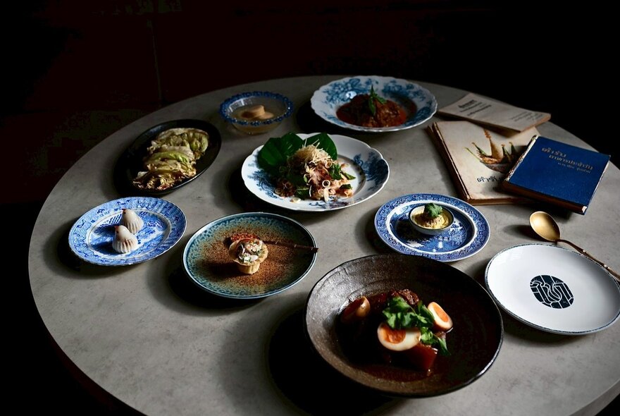 A table wth 9 plates of varying sizes with different offerings. 