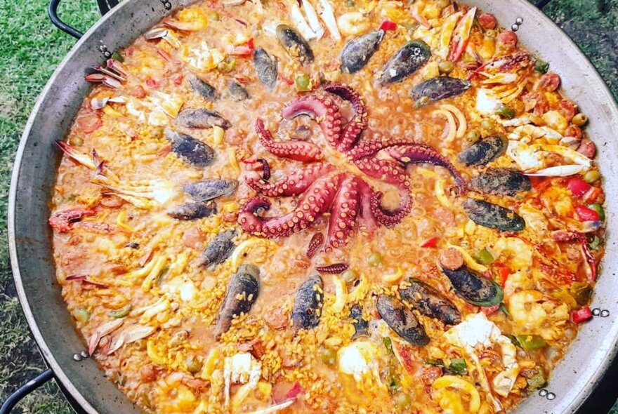 Looking down into a pan of seafood paella.