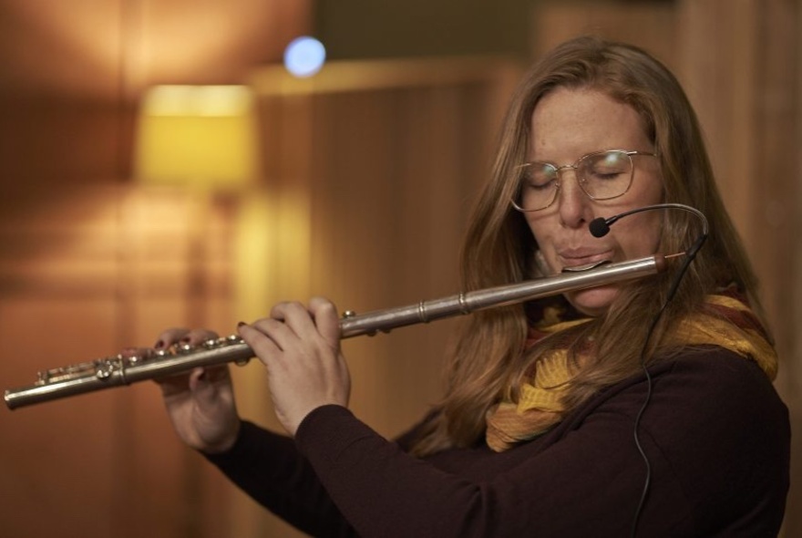 Student Composer in Residence, Leah Blankendaal playing the flute. 