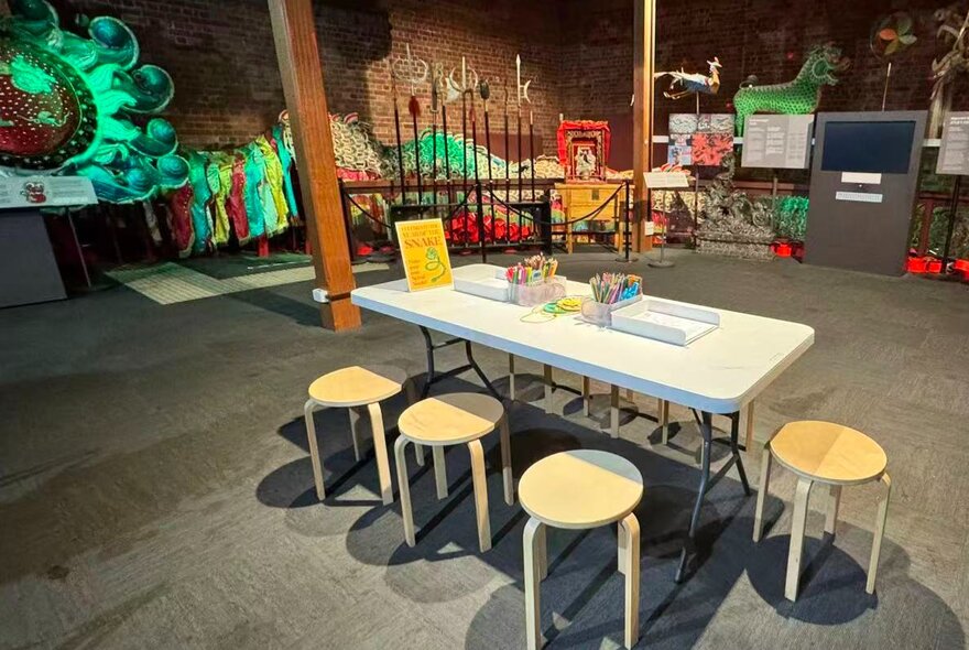 A worktable set up in a colourful open playspace for children.