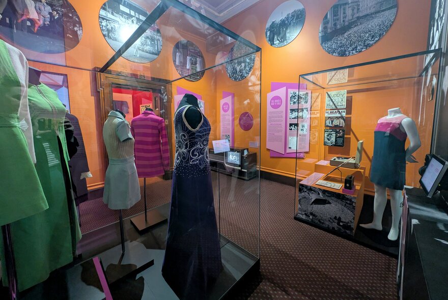 Garments on display in glass cabinets inside the Old Treasury Museum.