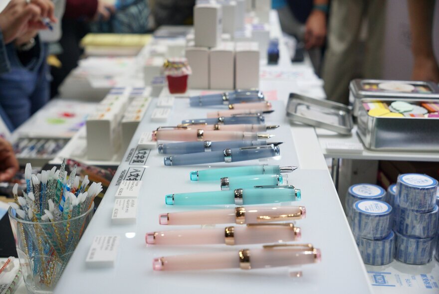 A selection of pearlescent pens presented on a white surface.