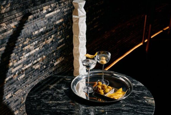 Martinis on a tray with garnishes.