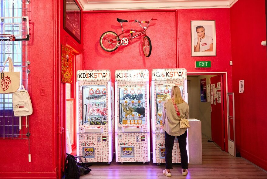 A woman is playing with a UFO game in a shop