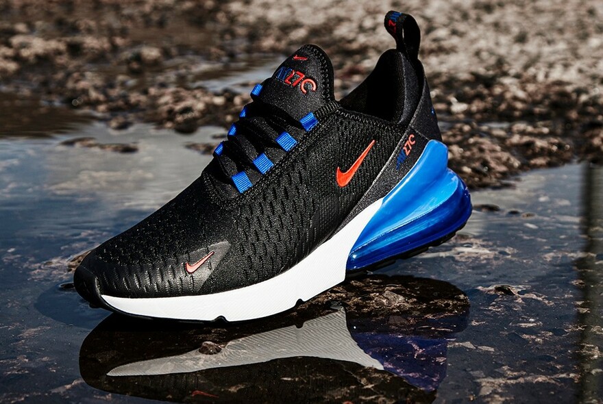 Single black, blue and white running shoe.