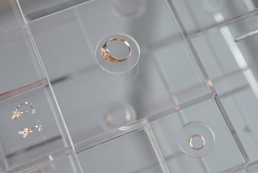 Jewellery on a glass counter display.