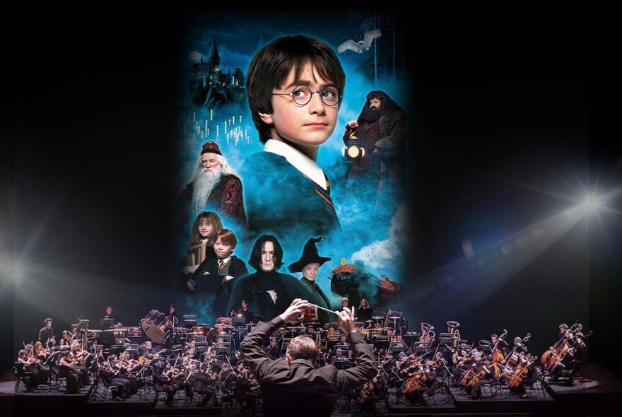 Conductor leading an orchestra seated performing in front of a huge screen displaying characters from Harry Potter.