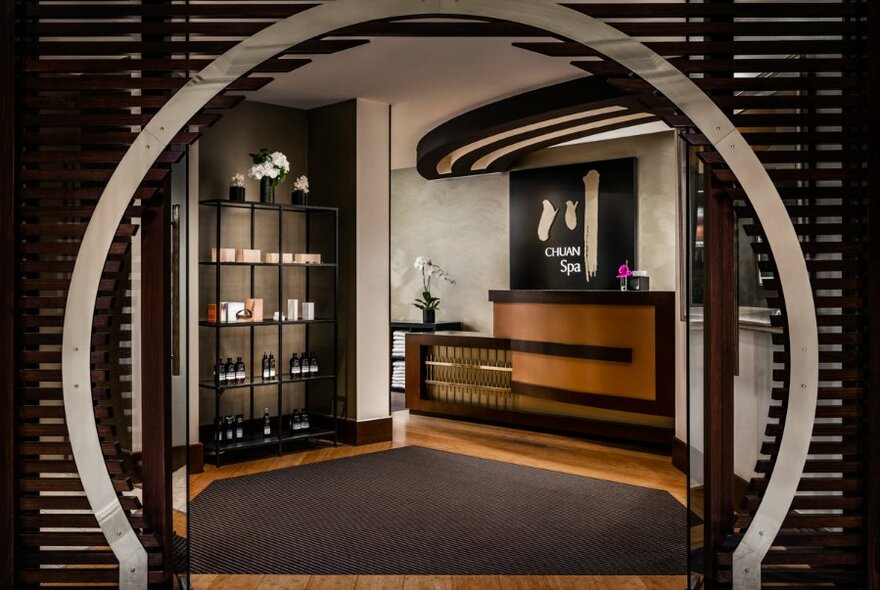 Circular doorway leading to a spa reception desk.