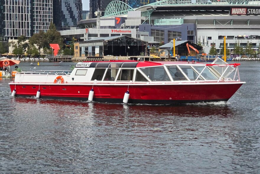 A red and white cruise boat on the Yarra River. 