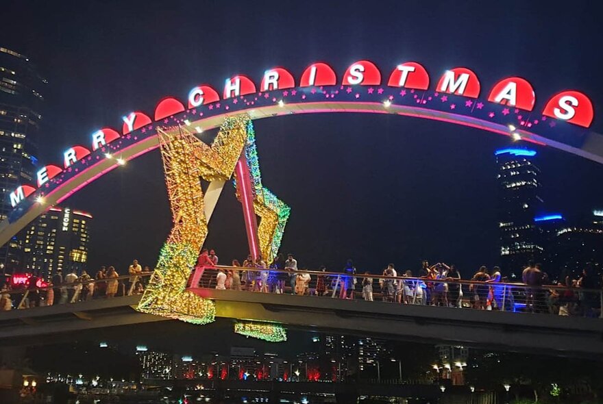 Bridge adored with Christmas displays and signage.