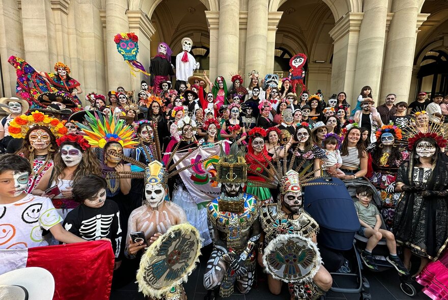 Day of the Dead performers in costume with audience in costume looking on.