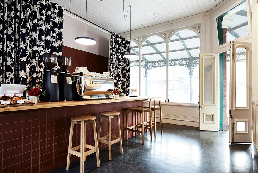 Coffee machine and counter in a cosy cafe.