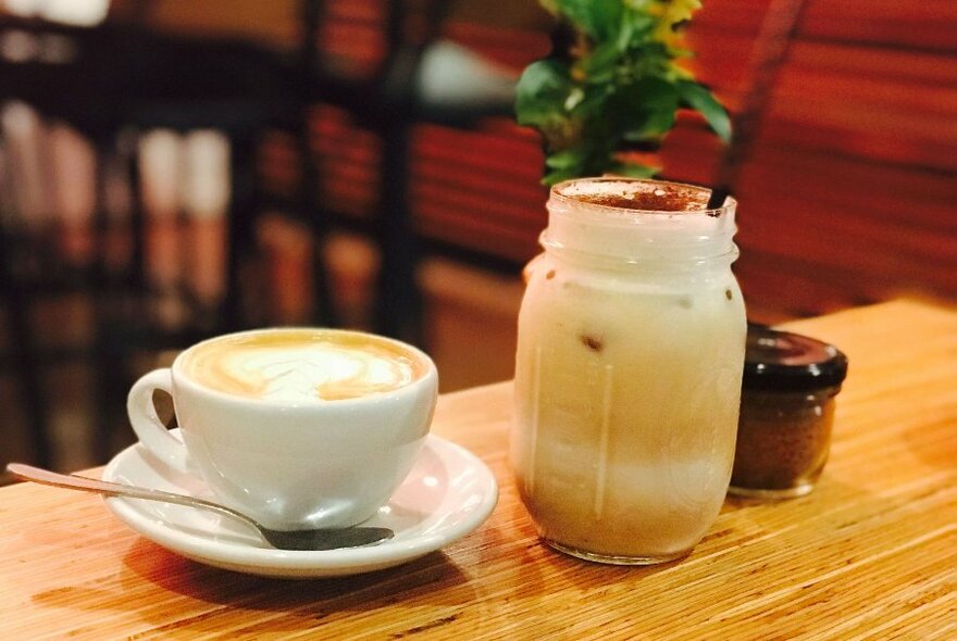 Cup of coffee and a drink in a jar.