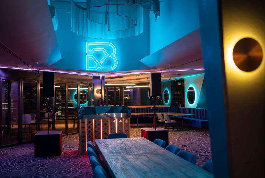 A bar with neon light accented lights around the room 