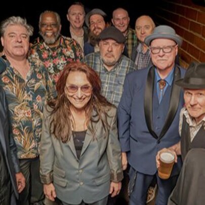 Large group of musicians, some wearing hats.