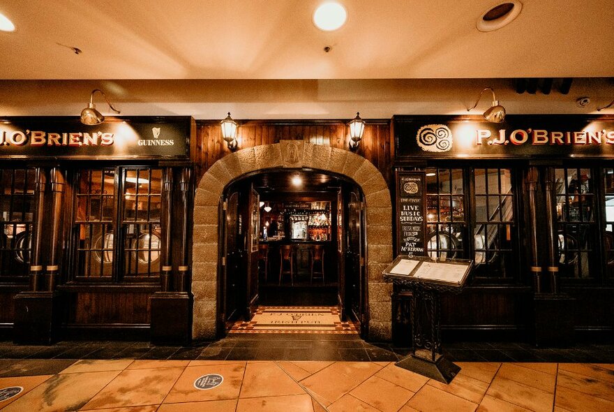 Exterior of PJ O'Brien's Irish Pub in a shopping mall, with arched doorway and timber windows.