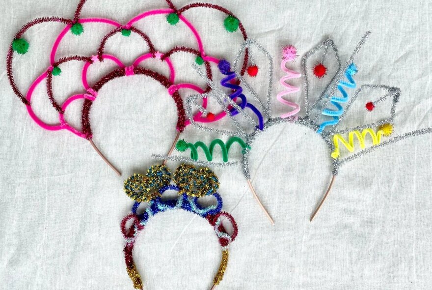 Three different crowns made from pipe cleaners and headbands.