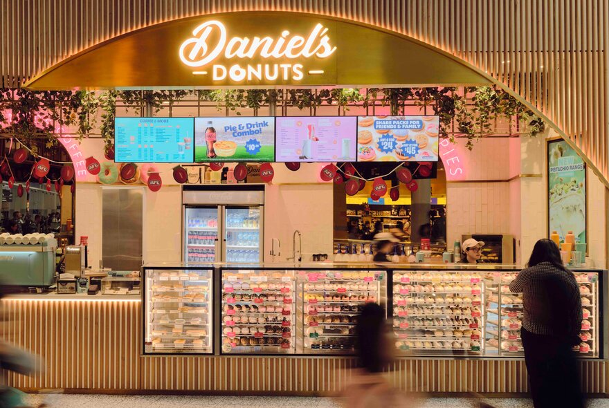 The shopfront of Daniel's Donuts with glass display cabinets filled with donuts.