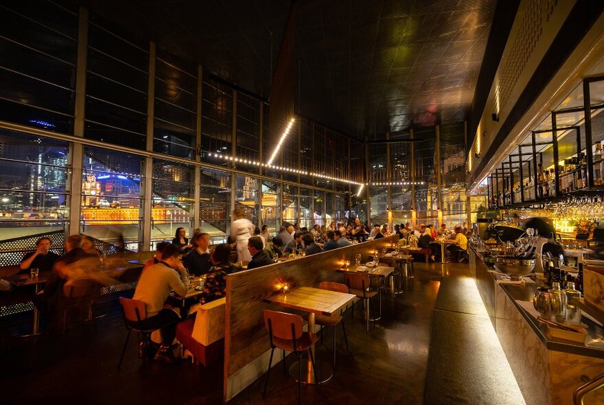 People seated in a restaurant at night.