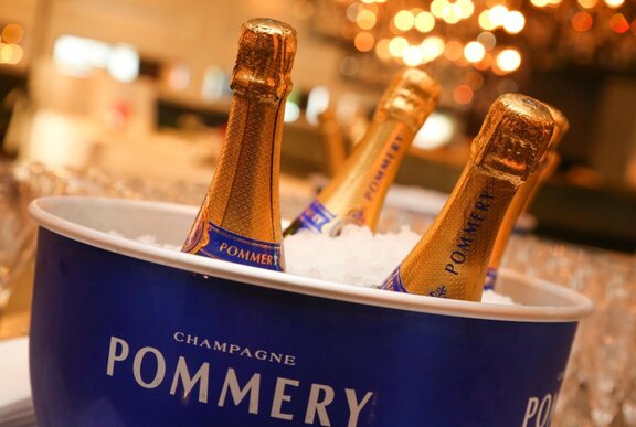 An ice bucket with three unopened bottles of Pommery champagne. 