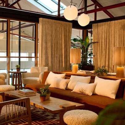 Upstairs hotel lounge with comfortable seating and low overhead lighting.