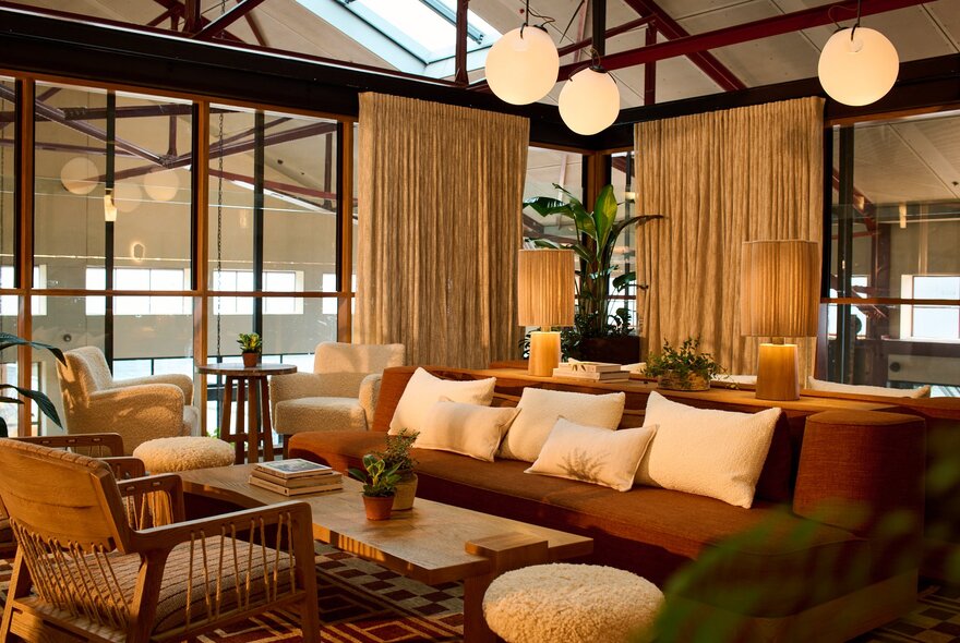 Upstairs hotel lounge with comfortable seating and low overhead lighting.