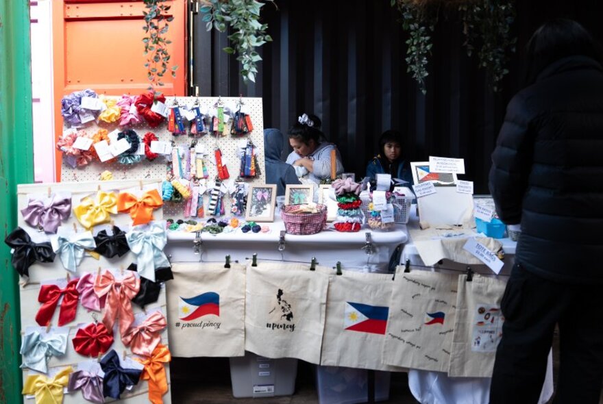 Indoor market stall selling ribbons and bows.