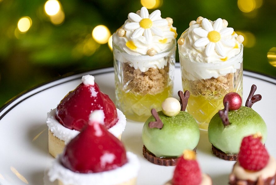 Small sweet treats on a white plate as part of a high tea spread.
