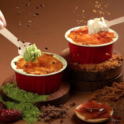 Two creme brulee cups with different flavoured filings. 