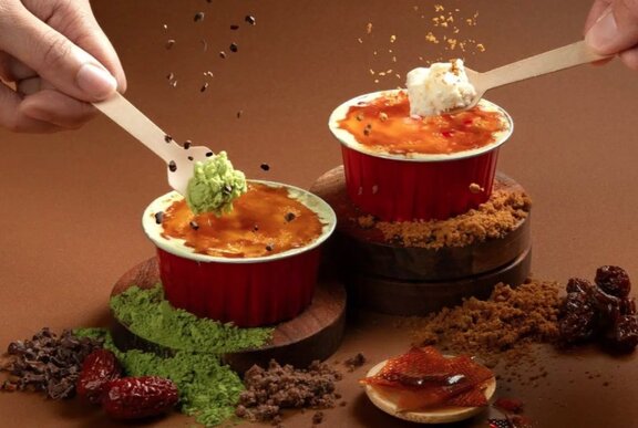 Two creme brulee cups with different flavoured filings. 