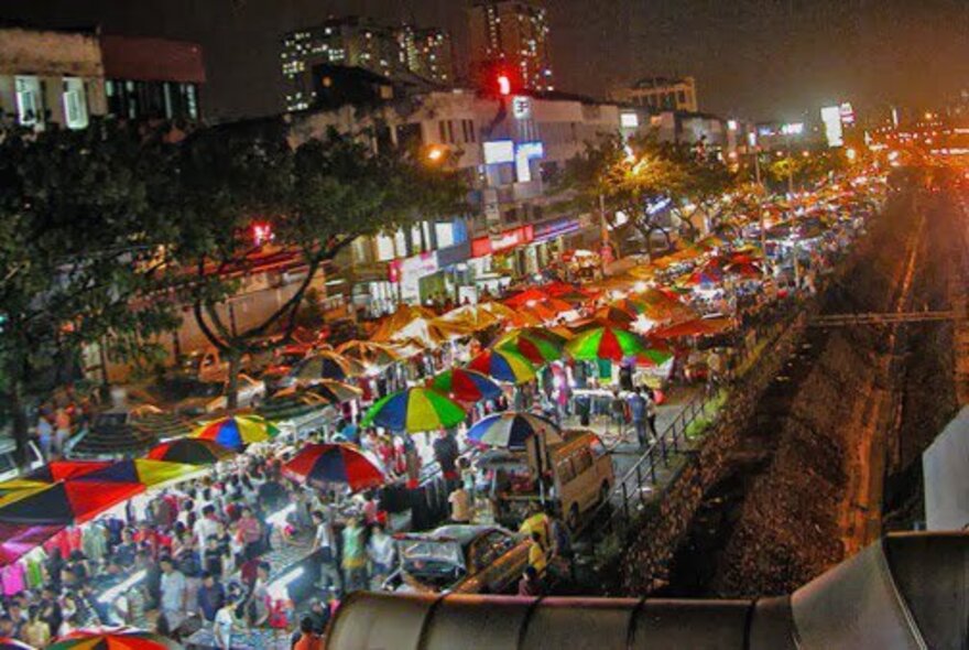 The Malaysian Night Market at Queensbridge Square, seen from above with rows and rows of colourful umbrellas and market stalls.
