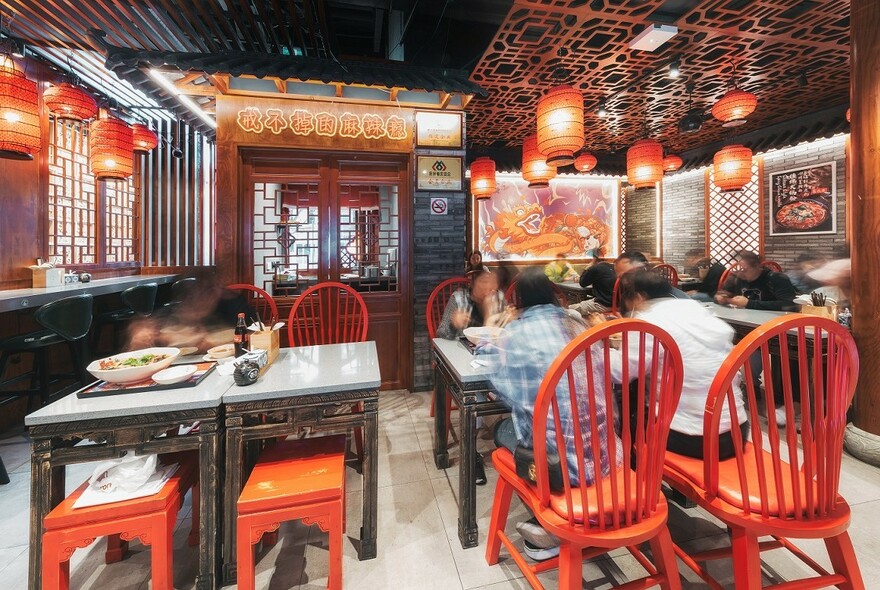 Red seats and lanterns in David's Spicy Pot Chinese restaurant.