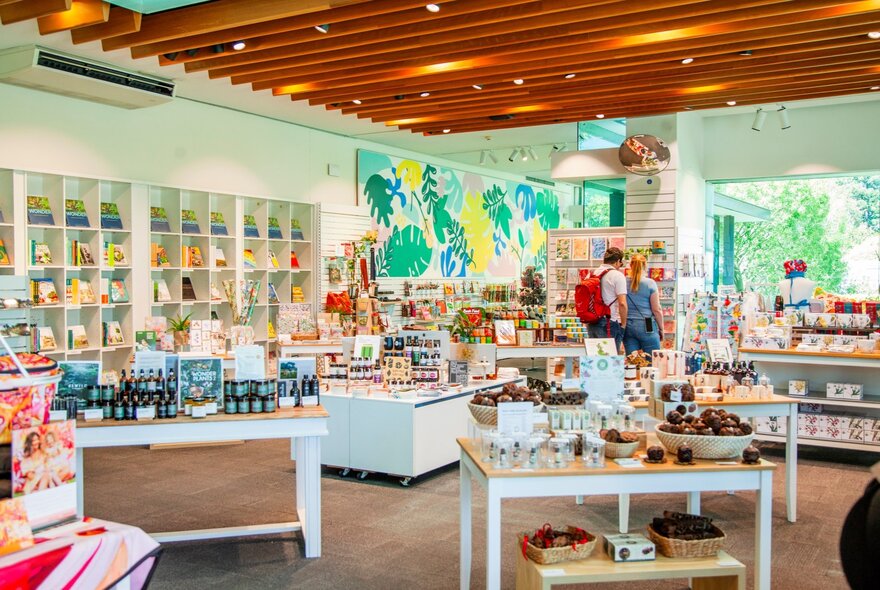 Botanical-themed shop with displays of products on tables, shelves and walls.