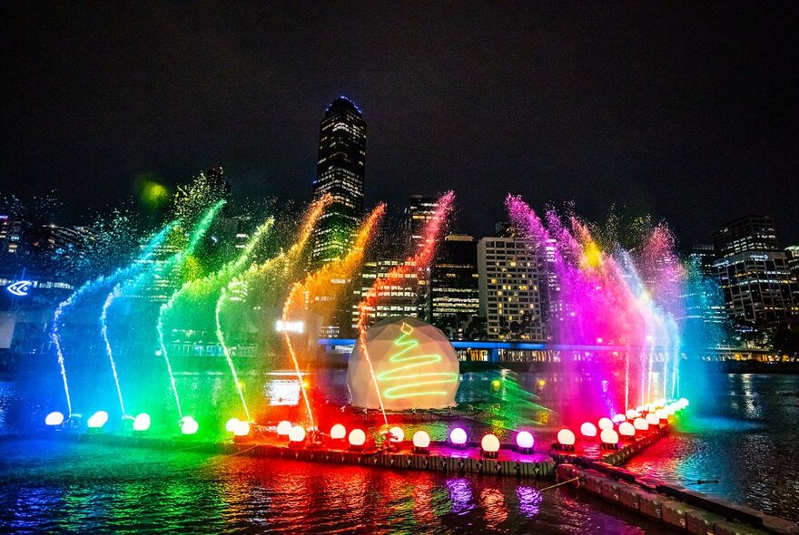 Laser lights and Christmas bauble installation illuminating the Yarra River at night.