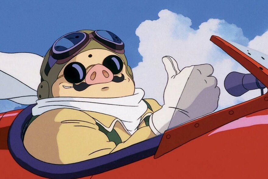 A still from a Studio Ghibli animated film of a pig like character with goggles perched on top of their head sitting behind the steering controls of a red plane in flight against a blue sky.