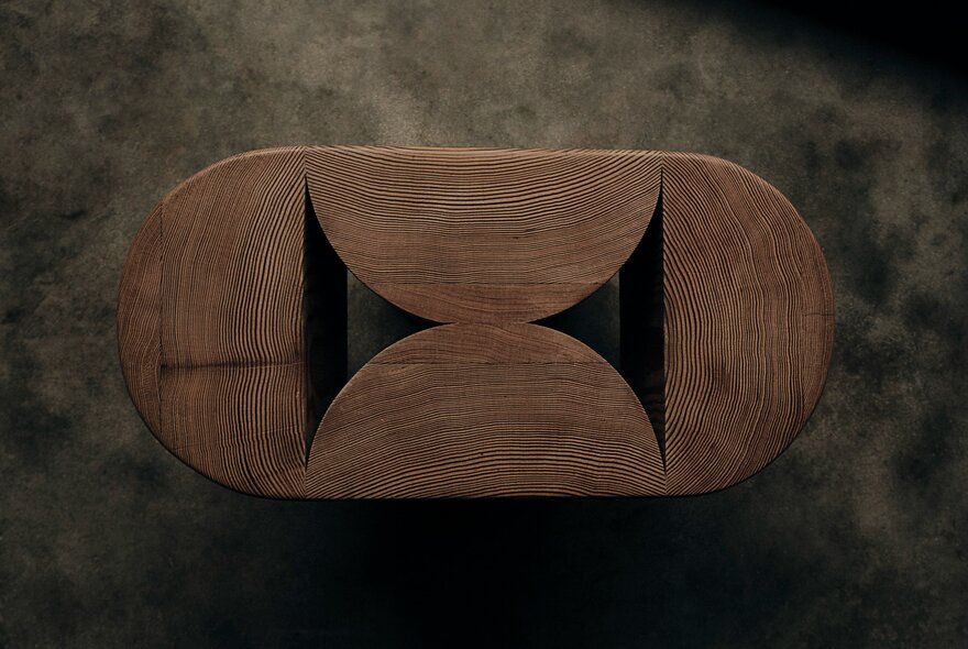 A piece of creative woodwork in an oval shape with triangular cutouts.