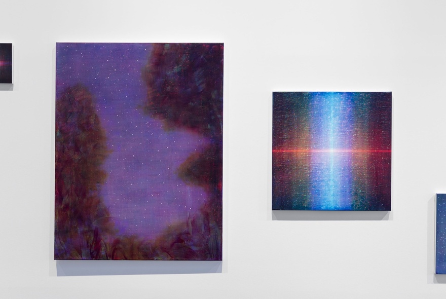 A gallery wall with two abstract paintings featured.