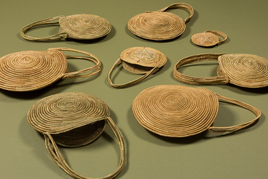 Gunditjmara Elder Aunty Connie Hart's fibre art with different woven scattered over a green surface. 