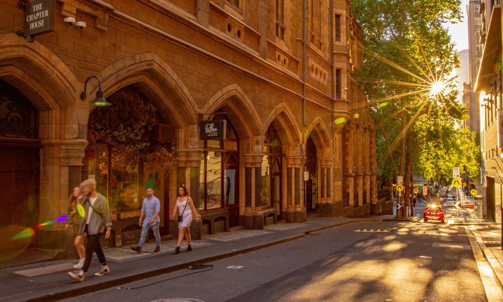 Sun lit city street with pedestrians