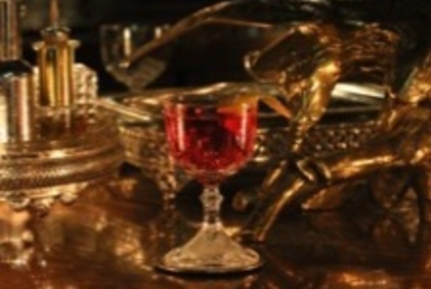 An cocktail in a sherry glass, on a silver tray. 