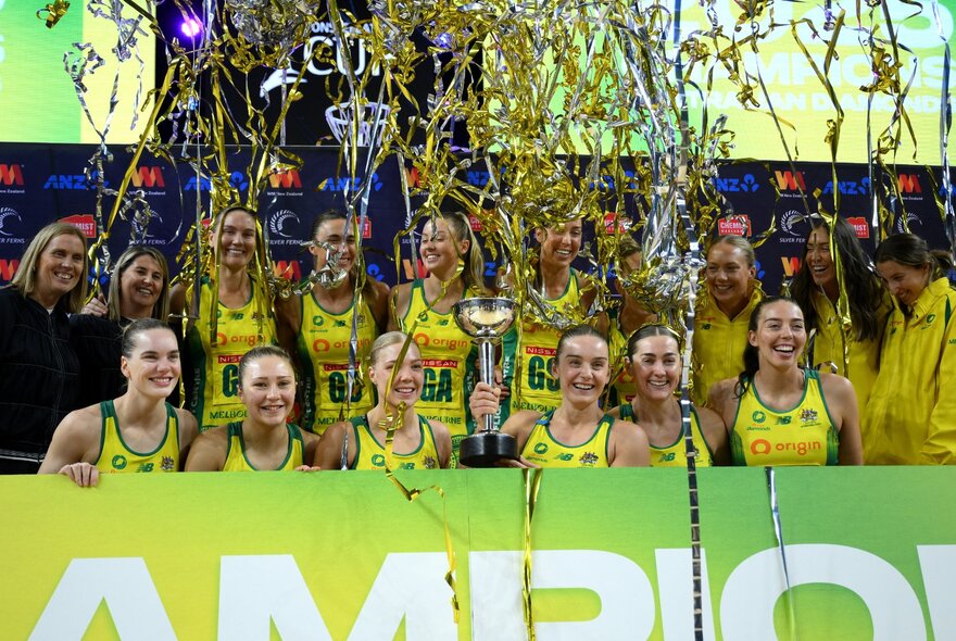Australian Diamonds netball team celebrating their 2025 Constellation Cup victory, streamers in the air above them as they pose for a team photo.