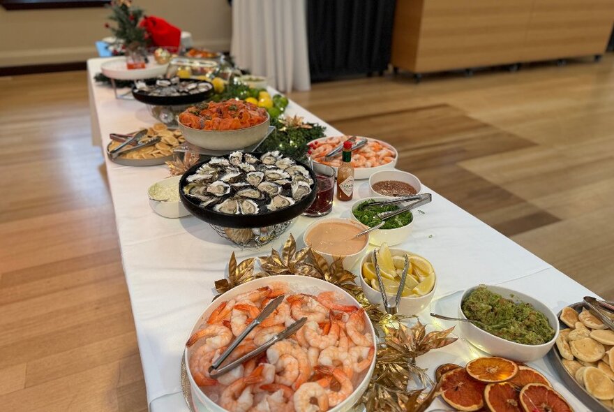 A long table set with a feast of seafood.