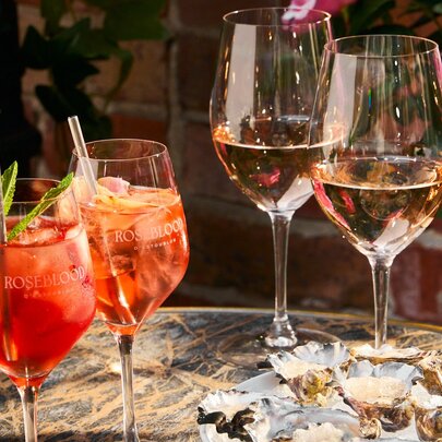 Glasses of rose and spritz with a plate of oysters. 