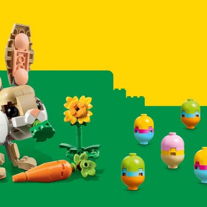 A LEGO Easter rabbit and Easter egg colourful display against a green and yellow background.
