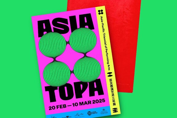 A poster for the event Asia TOPA and a Lunar New Year red envelope.