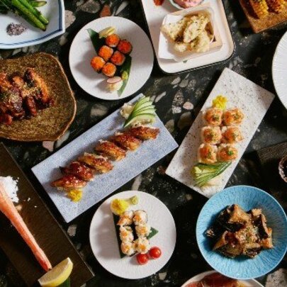 An array of Japanese foods on platters, seen from above.