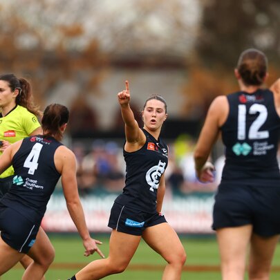 Carlton Blues AFLW players celebrating a goal on the field.
