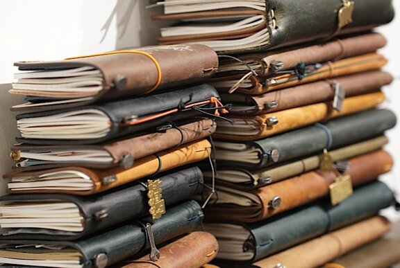 A stack of leatherbound notebooks.